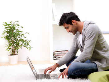 Mann arbeitet mit Laptop zu Hause